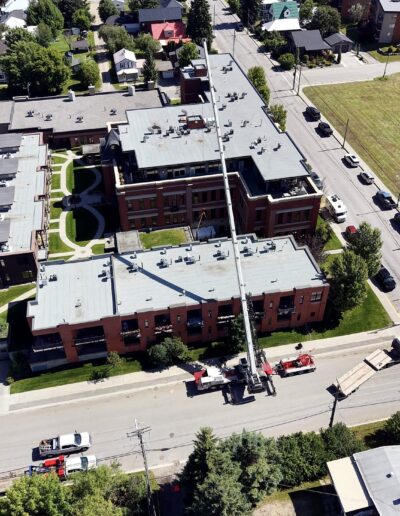 PJB Crane lift over a Sparwood building, aerial view